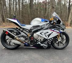 a motorcycle parked on the street in front of some trees