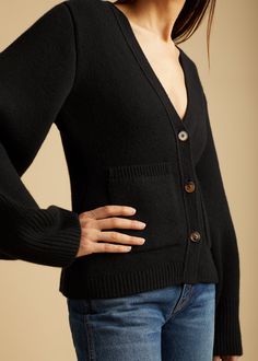 Description Accented by fisherman’s rib-stitched trim, patch pockets, and tortoiseshell buttons, this deep v-neck cardigan envelops the body in mid-weight cashmere selected for its exceptional softness and robust texture. The cropped silhouette is balanced by relaxed, extended sleeves. Details Material: Cashmere (95% cashmere 5% elastane)Care: Dry cleanFit: Runs true to size. Model is 5'9", wearing size S. Fall Cashmere V-neck Sweater With Button Closure, V-neck Cashmere Cardigan With Pockets, Black Wool Cardigan With Button Cuffs, V-neck Wool Cardigan With Pockets, Wool V-neck Cardigan With Pockets, Black Classic Cardigan With Pockets, Classic Black Cardigan With Pockets, V Neck Cardigan, Tortoise Shell