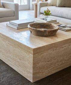 a wooden bowl sitting on top of a coffee table