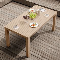 a wooden table with plates of food on it and cups of coffee next to it