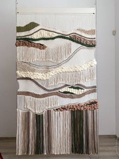 a wall hanging made out of yarn and rope