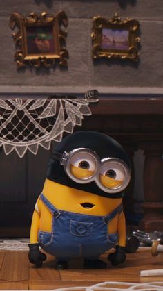 a minion sitting on the floor in front of a fireplace