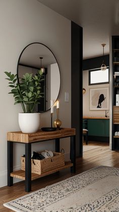 a living room with a large mirror on the wall next to a wooden table and rug