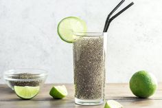 a glass filled with chia seeds next to limes