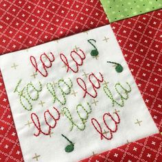 a red and green table cloth with embroidered happy new year's eve on it