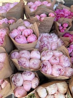 several bags filled with pink flowers sitting on top of each other