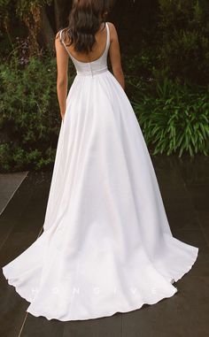 a woman in a white wedding dress looking back