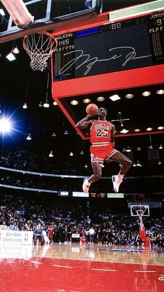 an autographed photo of michael jordan dunking the basketball in front of fans