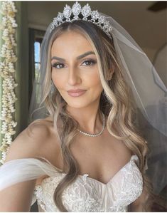 a woman in a wedding dress wearing a tiara