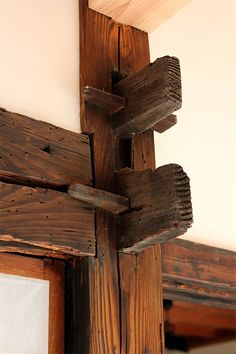 a wooden cross hanging from the side of a wall