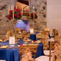 the tables are decorated with gold and blue linens