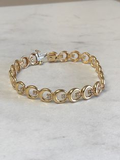 "14kt Yellow Gold Lady's Diamond 7\" Bracelet consisting of 22 full cut round brilliant diamonds 1/2ct total weight SI2 clarity, H color all set in 4 prong low base heads soldered inside bright polished custom made circles all hinged for maximum flexibility and comfortable movement. This well made diamond bracelet has a heavy hidden style clasp. You can be proud to wear this day after day either casual or formal for a grandeur look of elegance. The weight of the bracelet is 12.15 grams. This ite 14k Gold Brilliant Cut Diamond Bracelet For Anniversary, 14k Gold Diamond Bracelet With Brilliant Cut For Anniversary, 14k Gold Bracelet With Diamond Accents, White Gold Bracelet With Diamond Accents, Round Cut Diamond Gold Bracelet For Anniversary, Anniversary Gold Bracelet With Round Cut Diamond, 14k Gold Round Diamond Bracelet Fine Jewelry, 14k Gold Round Diamond Bracelet For Anniversary, 14k Gold Diamond Bracelet For Anniversary