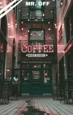 the entrance to a coffee shop with red lights