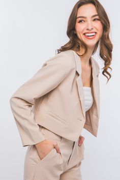 Effortlessly elevate your professional wardrobe with our Long Sleeve Vertigo Cropped Blazer Jacket. Made from a luxurious blend of 95% polyester and 5% spandex, this imported jacket is both comfortable and stylish. Perfect for any occasion, from the office to a night out, it's a must-have addition to your wardrobe. 95% POLYESTER, 5% SPANDEX Import Tailored Cropped Jacket With Lapel Collar For Semi-formal Occasions, Semi-formal Tailored Cropped Jacket With Long Sleeves, Beige Tailored Cropped Jacket With Long Sleeves, Tailored Semi-formal Cropped Jacket With Lapel Collar, Fitted Beige Cropped Jacket With Lapel Collar, Dress With Cropped Jacket, Feather Graphic, Cropped Blazer Jacket, Beige Blazer