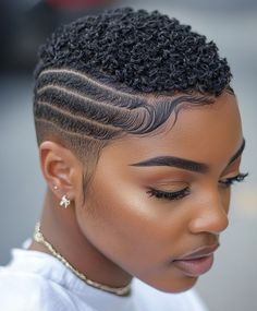 This very short style focuses on styling the baby hairs around the hairline to create intricate patterns. It adds a feminine touch to an otherwise edgy, short cut. Baby Hair Styling, Ladies Hairstyles, Short Haircuts For Black Women, Black Hair Short Cuts, Shaved Hair Cuts, Haircuts For Black Women, Tapered Natural Hair