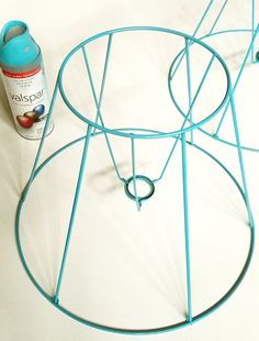 a spray can sitting on top of a table next to a metal rack with circles