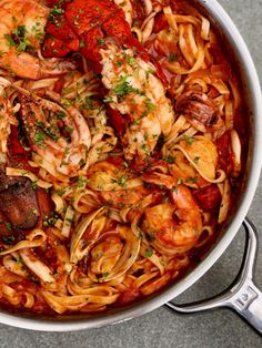 a large pot filled with pasta and shrimp