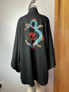 ~price reduced 12/24~ I picked up this neat woolen knit kimono recently. It's unusual in that it seems to be made from a kind of jersey wool. It's black and has a large dragon hand embroidered on the back side.  It was missing its sash/belt but hopefully you can find something to use in replace of that. It still has 2 belt loops on each side.  Or one could wear it just open style, loose or use an actual belt of sorts.  Sorry, yes it would have been ideal to have this piece.  The only flaw to the Wool Kimono, Dragon Hand, Large Dragon, Knit Kimono, Embroidered Dragon, Half Jacket, Mode Kimono, Embroidery Materials, Sash Belt