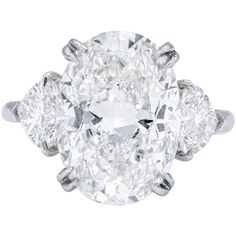 an oval cut diamond ring with three pear shaped diamonds on the shoulders and side stones