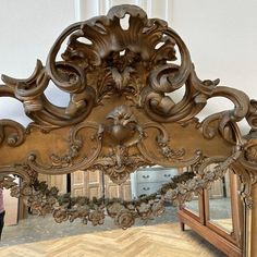 an ornately carved wooden bed frame with mirror