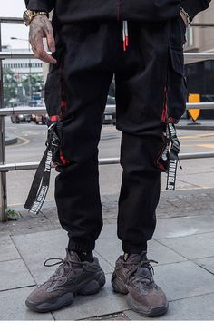 Men can sport a bold look by wearing these cargo pants. These full-length hip-hop pants are crafted from soft cotton. The harajuku joggers’ pants come with ingenious tactical zipper pockets that provide security. The streetwear is available in multiple sizes and comes in black color along with elastic mid-waist closure.

Specifications
Brand Name: GeraldBlack
Pant Style: Cargo Pants
Length: Full Length
Front Style: Flat
Fit Type: REGULAR
Material: COTTON
Thickness: Midweight
Fabric Type: Broadcl Harajuku Style Black Pants With Pockets, Harajuku Black Pants With Pockets, Baggy Harajuku Style Cargo Pants, Harajuku Style Baggy Cargo Pants With Pockets, Hip Hop Style Cotton Cargo Jeans For Outdoor, Hip Hop Cargo Jeans With Side Pockets For Outdoor, Black Harajuku Streetwear Pants, Harajuku Style Cargo Pants For Streetwear, Harajuku Style Cotton Bottoms With Cargo Pockets