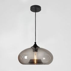 a clear glass light hanging from a black metal ceiling fixture with two bulbs on each end