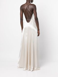 the back of a woman wearing a white dress with an open back and straps on it