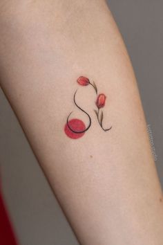 a woman's arm with a flower tattoo on the left side of her arm