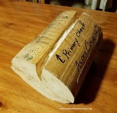 a piece of wood with writing on it