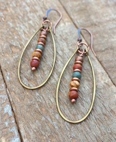 "Hammered copper hoop earrings with red creek jasper dangles. One of my original and most popular designs in the hammered hoop collection. Made with earthy, colorful Red creek jasper and antiqued copper, these light-weight earrings will add a pop of color to your favorite outfit whether it be jeans and a t-shirt or a dress. Red creek jasper is a beautiful stone that can vary from reds and oranges to blues and greens, and each pair of these earrings made will be similar yet unique, just for you. Clip Ideas, Hammered Copper Earrings, Red Creek Jasper, Earthy Jewelry, Simple Hoop Earrings, Jasper Jewelry, Natural Stone Earrings, Project Board, Wrapped Earrings