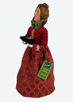 a figurine wearing a red dress and green scarf