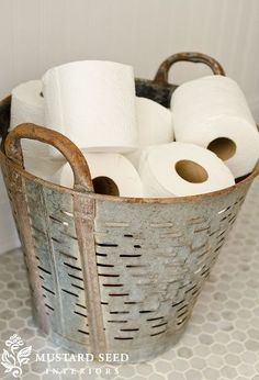 several rolls of toilet paper in a metal basket