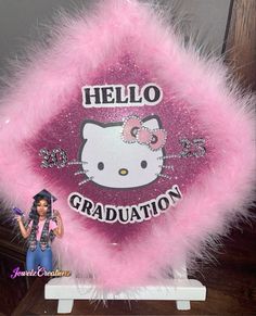 a pink hello kitty graduation decoration on display