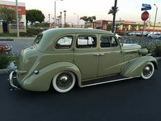 an antique car parked in a parking lot