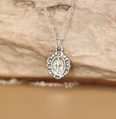 Virgin mary necklace - sterling silver virgin mary necklace - religious necklace A tiny sterling silver virgin mary hangs on a 16 inch sterling silver chain. Please feel free to select a different length chain if you prefer! This beauty is also available in gold vermeil. This little beauty measures 9mmx7mm More from BubuRuby? https://www.etsy.com/shop/BubuRuby?ref=hdr_shop_menu Looking for other charm necklaces? https://www.etsy.com/shop/BubuRuby?section_id=12318467 More crystals and healers? ht Mary Necklace, Virgin Mary Necklace, Charm Necklaces, Necklace Sterling Silver, Virgin Mary, Sterling Silver Chain, Pure Silver, Sterling Silver Chains, Precious Metals