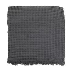 a gray blanket with fringes on it