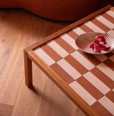 a table with a flower on it and a checkerboard board pattern in the middle