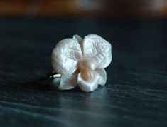 "This delicate white pearl orchid ring is made from polymer clay with special cover. ALL BASES ARE ADJUSTABLE ;  silver plated base 6.5-8.5/ 16.9-18.5 mm 925 sterling silver adjustable base 5.5-8/ 15.9-18 mm or 7-9  gold plated sterling silver 925  base 5.5-8 us/15.9-18 mm or 7-9  925 silver base 4.5-8 us Large Orchid sizes about 28*28 mm/ 1,1*0,98 inch Small orchid size about  18*18 mm/0,7*0,7\" Also I have bases with other adjustable sizes (6-8 size in gold, silver and bronze colors). If you need other base for this rose just let me know and I create it for you PEARL ROSE RING: https://www.etsy.com/listing/464029122/pearl-ring-polymer-clay-ring-pearl-rose?ref=shop_home_active_16 The ring is adjustable and can fit any size by gently pushing together the ends, overlapping them or gently pu Unique White Flower Ring, Elegant Handmade White Flower Ring, Orchid Ring, Clay Silver, Silver Rose Ring, Polymer Clay Ring, Rose Gold Plated Ring, Ring Pearl, Clay Flower