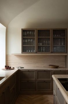 a kitchen with wooden cabinets and white counter tops