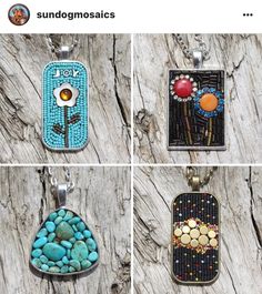 four pendants with different designs on them sitting on a piece of driftwood next to each other