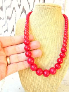 "Simply stunning red. This graduated necklace is made from red howlite semi precious stones. The stones range in size from 14mm - 5mm. Choose from a lobster claw closure or a toggle closure. The lobster claw closure will have a 2\" extender chain the toggle closure will be a fixed length. Find matching EARRINGS here: https://www.etsy.com/shop/JensBeadBox?section_id=10618715&ref=shopsection_leftnav_5 See more of my handmade jewelry here: https://www.etsy.com/shop/JensBeadBox?ref=shopsection_s Red Wooden Beaded Necklaces, Red Wooden Beaded Necklace, Red Necklace With Wooden Beads, Red Wooden Beads Round Necklace, Red Coral Beaded Necklace With Wooden Beads, Red Necklaces With 8mm Beads For Jewelry Making, Red 8mm Bead Necklace, Red Wooden Beaded Necklaces As Gifts, Red Wooden Beaded Necklaces For Gifts