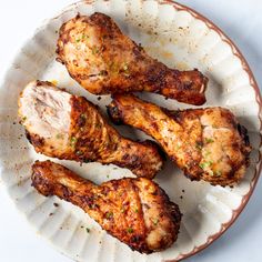 four pieces of chicken on a white plate