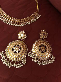 Gold plated kundan set necklace earrings and mang teeka. Made to order and ready to ship in 4 to 6 weeks. Temple Jewelry With Mirror Work For Eid, Silver Kundan Necklace With Gota Work For Party, Gold Temple Jewelry Sets With Mirror Work, Festive Kundan Jewelry Sets With Mirror Work, Kundan Jewelry With Mirror Work, Kundan Chandbali Jewelry Sets For Eid, Kundan Chandbali Necklace With Mirror Work, Kundan Chandbalis With Mirror Work For Celebration, Kundan Necklace With Mirror Work For Celebration