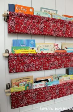 two bookshelves with red and white bandana fabric hanging on the wall next to each other