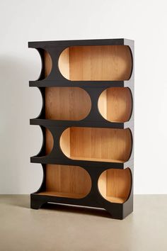 a wooden shelf with several compartments on each side and one section open to show the inside