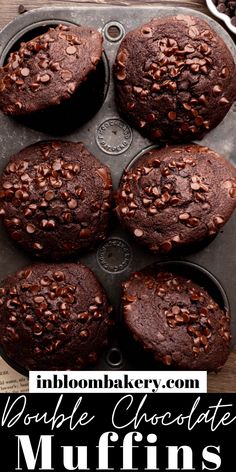 chocolate muffins in a muffin pan on top of an open book and coffee cup