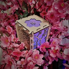 a paper box sitting on top of pink flowers