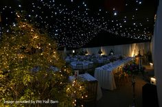 the ceiling is covered with stars and lights in an indoor event venue at night time