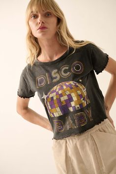 Mineral washed graphic t-shirt. Vintage-style disco ball graphic print with "Disco Baby" text print in retro disco font. Lettuce-edge detailing at hem and cuffs. Round neckline. Short sleeves. Cropped length. Relaxed fit. 100% Cotton. Imported top designed and printed in LA. Model wears size S. Retro Letter Print Tops For Festival, Vintage Summer Party T-shirt, Party Cotton Tops With Screen Print, Vintage Letter Print Tops For Party, Vintage Party Tops With Letter Print, Grunge Crew Neck Party Top, Grunge Crew Neck Top For Party, Disco Style Cotton Short Sleeve Tops, Disco Style Cotton Top With Short Sleeves