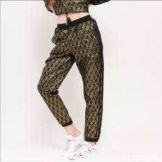 1970 Honor Its 50th Anniversary In These Track Pants, With A Metallic Monogram Design Featuring The Shell Toe Specifications Regular Fit Drawcord On Elastic Waist 85% Polyester 15% Metallized Fiber Jacquard Track Pants With Metallic-Gold Thread Side Welt Pockets Ribbed Cuffs Imported Black / Gold Metallic Washing Instructions Do Not Bleach Do Not Tumble Dry Do Not Dry Clean Do Not Iron Machine Wash Cold Delicate Cycle Use Mild Detergent Only Wash Separately Wash Inside Washing Bag Retro Black Bottoms For Night Out, Adidas Fitted Sweatpants, Adidas Fitted Sweatpants For Spring, Adidas Fitted Bottoms For Streetwear, Adidas Fitted Pants For Streetwear, Adidas Jogging Pants, Paris Living, Adidas Soccer Pants, Iron Machine